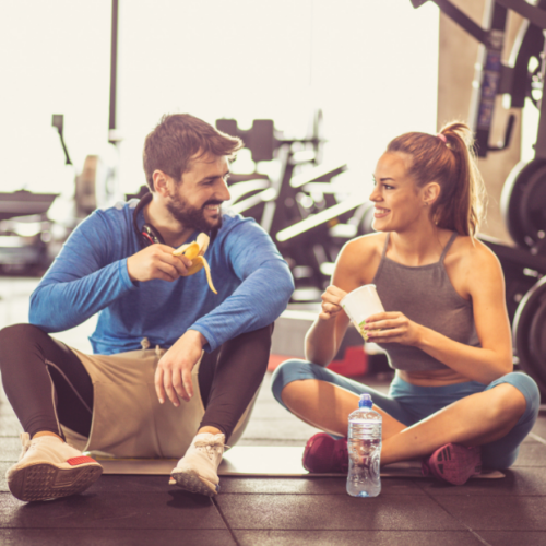 Man and Woman Sitting, Talking at the Gym