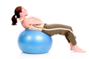 Woman doing situps on an exercise ball.