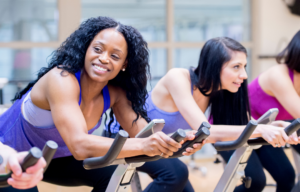 Women at Gym on Exercise Bikes