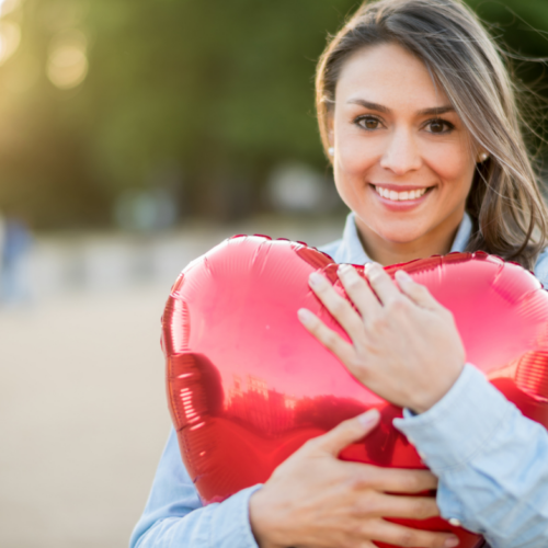 Woman Hugging Heart Balloon
